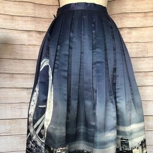 Midi full pleated satin skirt w/ whimsical print.